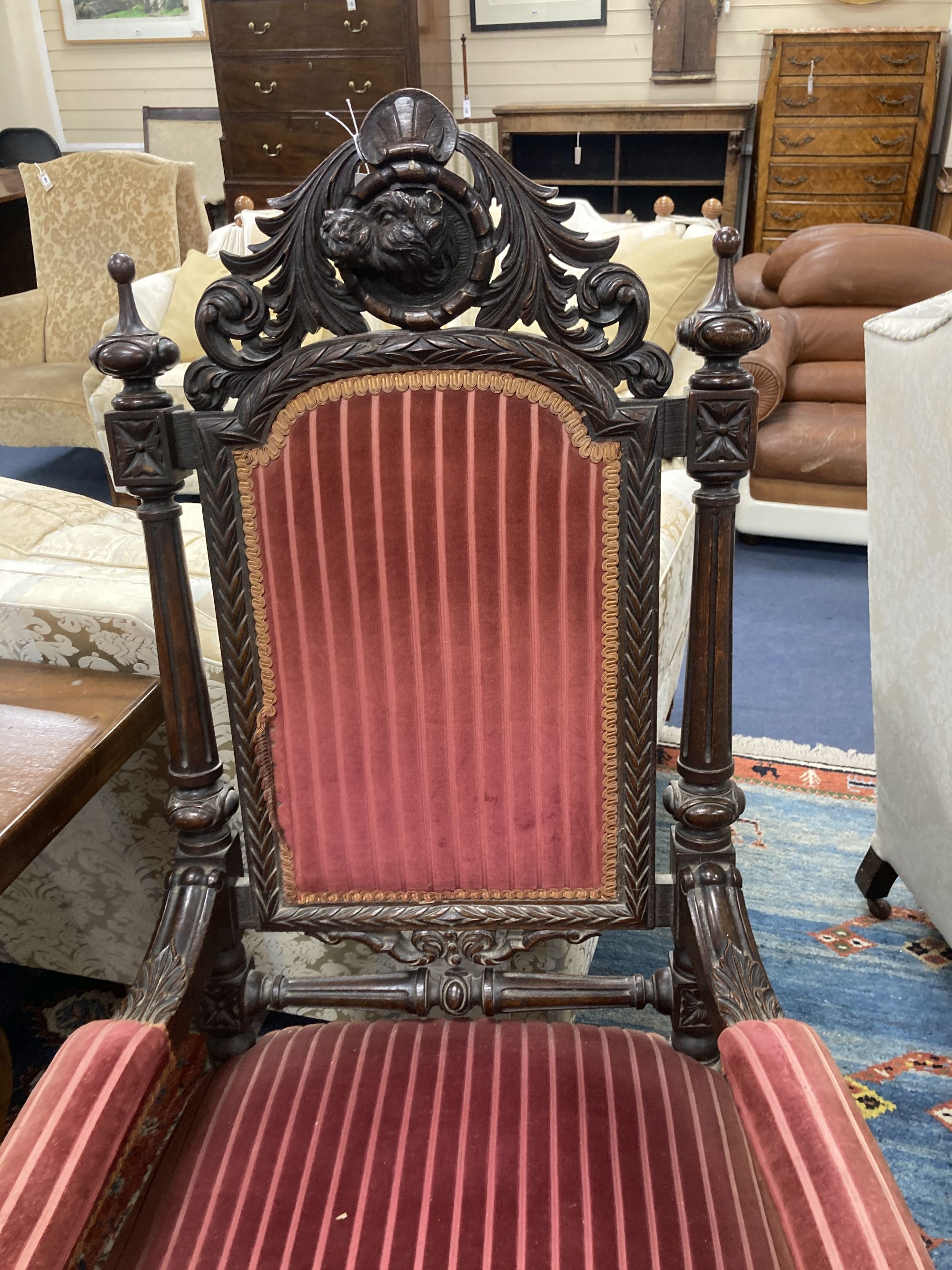 A late 19th century oak Carolean style armchair, with carved dogs head arms, width 68cm, depth 66cm, height 130cm